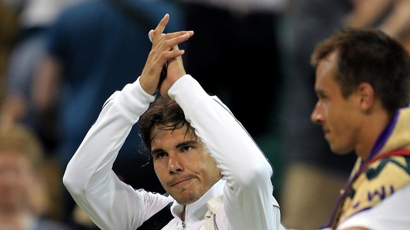 Nadal waves goodbye to the Wimbledon crowd.