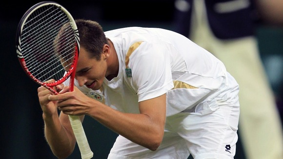 Rosol collapses to his knees after beating the two-time champion on Centre Court.