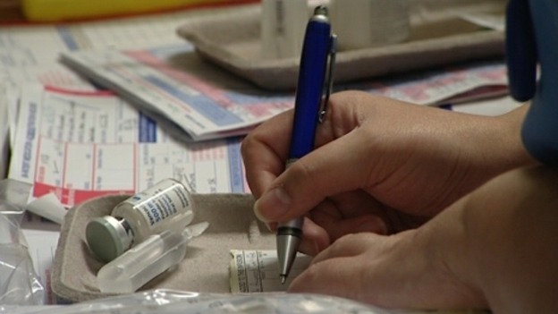 A nurse filling in paperwork