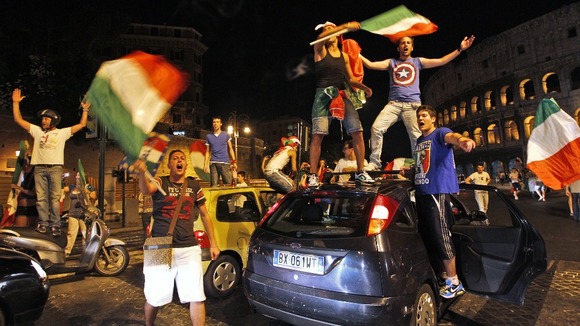 Italian fans celebrate the win in front of Rome's ancient Colosseum.