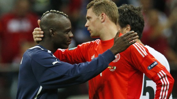 Germany goalkeeper Manuel Neuer is comforted by Italy's Mario Balotelli in Warsaw.
