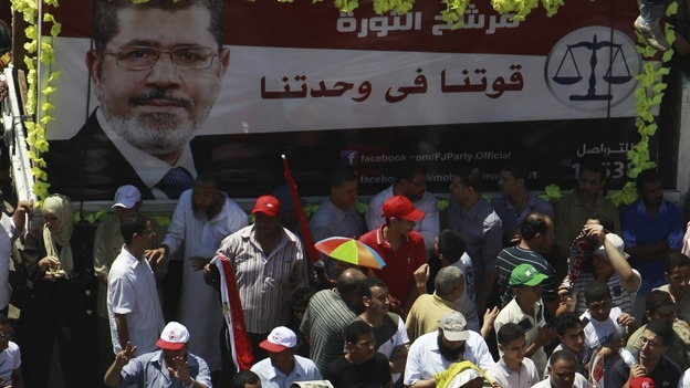 Supporters of Egyptian President-elect Mohamed Morsi shout anti-military council slogans at Tahrir square in Cairo