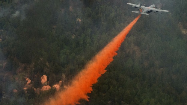 US Air Force C-130 Hercules aircraft spreading fire retardant