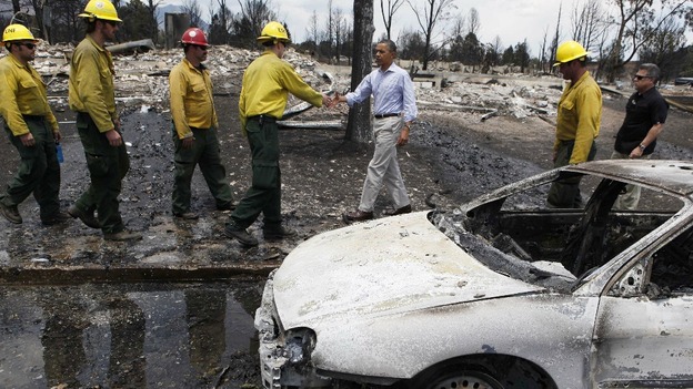 US President Barack Obama surveys fire damaged area with fire fighters in Colorado Springs