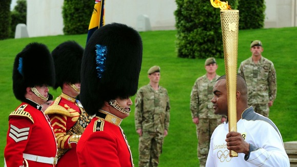 Corporal Johnson Beharry VC carries the torch at the National Memorial Arboretum on Armed Forces Day