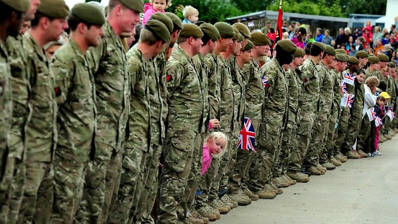 A child waits to see the Olympic torch at the National Memorial Arboretum