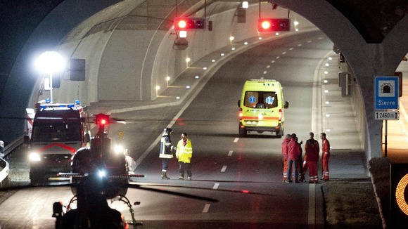 Rescuers work at the tunnel entrance after a bus crashed in the tunnel, in Sierre, Switzerland.