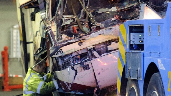 The wreckage the bus from Belgium is loaded onto a tow truck in Sierre, Switzerland.
