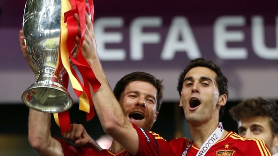 Spain midfielder Xabi Alonso lifts the trophy.