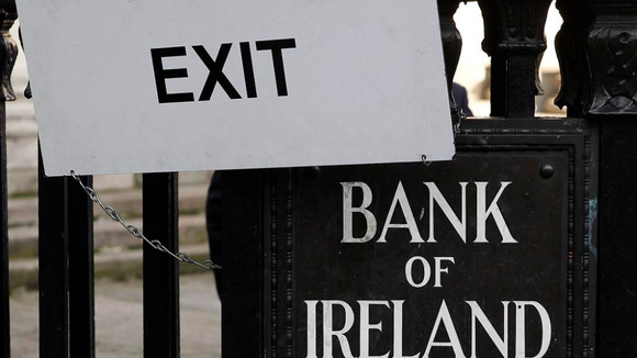 A sign hangs on the railings of the Bank Of Ireland, in central Dublin