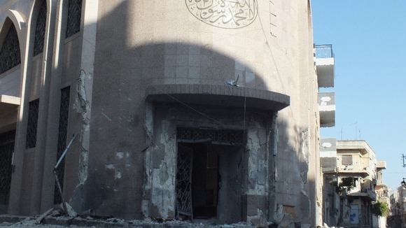 Damaged entrance of a mosque in Homs after fighting between Syrian rebel fighters and Bashar al-Assad's forces.