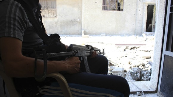 A member of the Free Syrian Army keeps watch in Baba Amr neighbourhood in Homs.