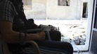A member of the Free Syrian Army keeps watch in Baba Amr neighbourhood in Homs.