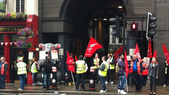 Union members wave placards and flags.