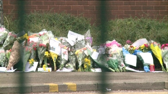 Floral tributes through gates