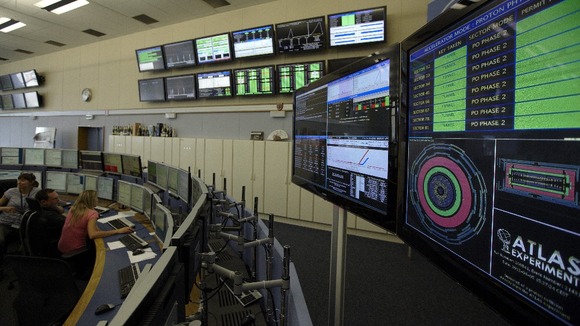 Technicians look at computer screens during the preparation of the beam in the Control Room of the Large Hadron Collider at Cern.