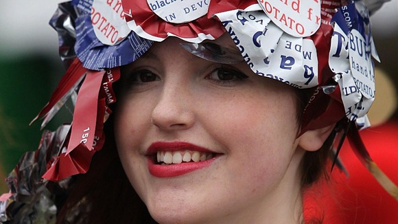 Racegoer models  headpiece made from recycled crisp packets 