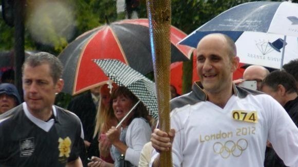 Alan Bowen takes the torch along the London Road.
