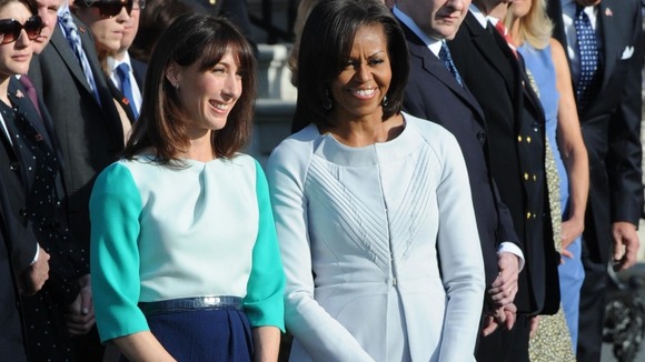amantha Cameron and Michelle Obama smile on for pictures together on the White House lawn.