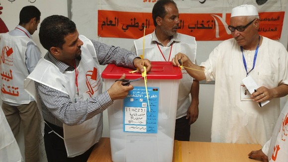 Libyans count votes after the polling station closed in Tripoli