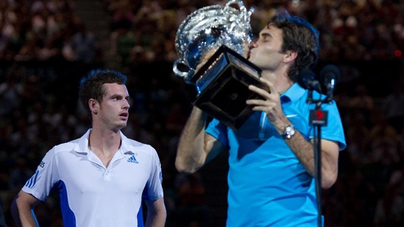 Murray looks away as Federer lifts the 2010 Australian Open trophy, after beating the Scot in the final.