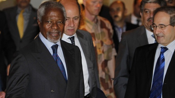 Syria's Deputy Foreign Minister Faisal al-Miqdad welcomes UN-Arab League envoy Kofi Annan at a hotel in Damascus