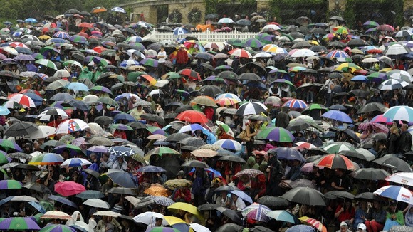 Tennis fans used umbrellas as the rain started to fall on Murray Mount in Wimbledon