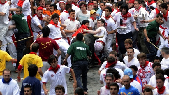 A man flees a charging bull at the San Fermin festival in northern Spain.