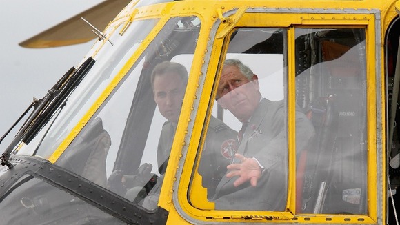 Duke of Cambridge shows the Prince of Wales one of the Sea King helicopters he captains during a tour of RAF Valley on Anglesey