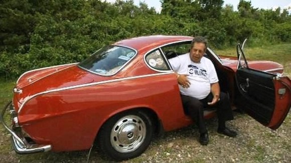 Irvin Gordon sits in his beloved 1966 Volvo coupe