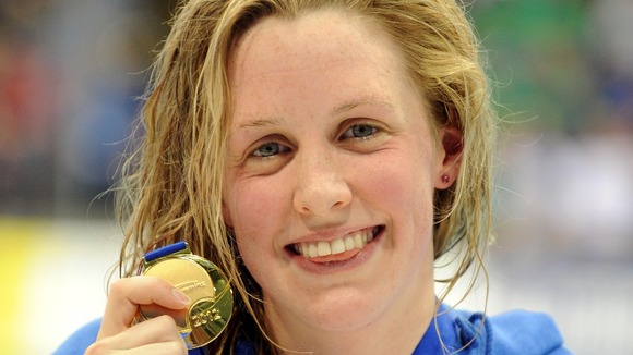 Hannah Miley celebrates with her gold medal after victory in the women's 200m individual medley at the British Gas Swimming Championships.