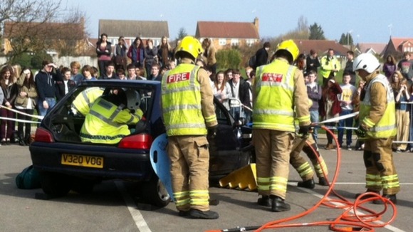 Fire fighters free trapped motorists in a road crash reconstruction
