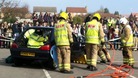 Fire fighters free trapped motorists in a road crash reconstruction