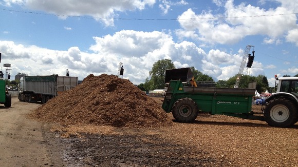 Tractors move wood chippings around the site.