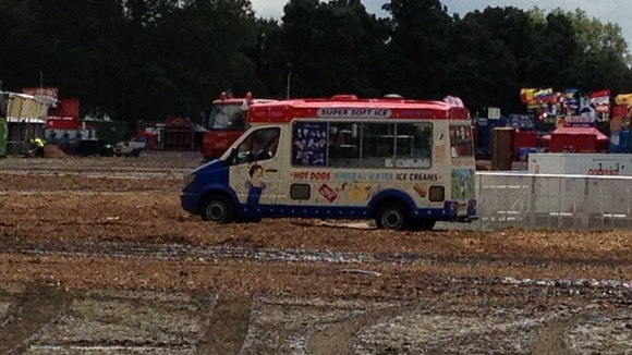 An ice cream van stranded in the mud.