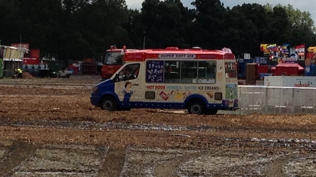 An ice cream van stranded in the mud.