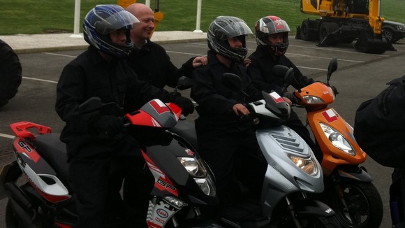 The triplets all arrive to work together on their 50cc scooters
