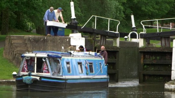 A boat coming through lock gates at Hatton Locks in Warwickshire
