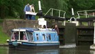 A boat coming through lock gates at Hatton Locks in Warwickshire