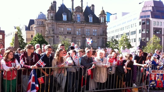 People waiting at the barriers to see The Queen and The Duke of Edinburgh