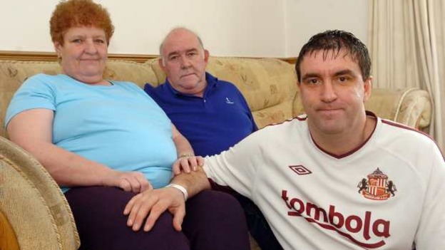 Man with parents on sofa