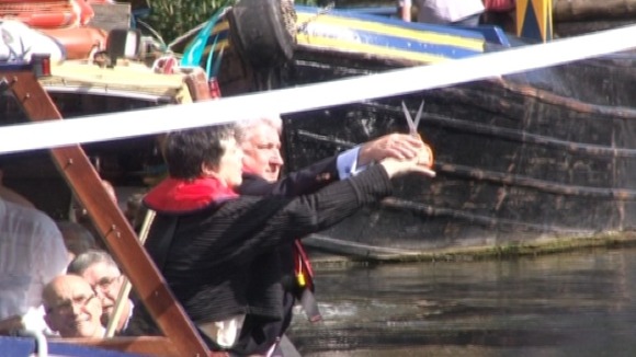 Ribbon being cut over a canal in Birmingham to mark the handover to the Canal & River Trust