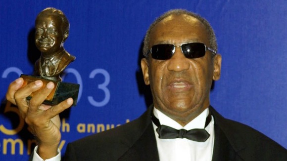 Bill Cosby holding the Bob Hope Humanitarian Award