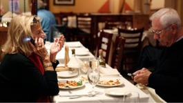 Diners on the phone in a restaurant
