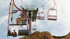 Torchbearer David Ouston carrying the Olympic Flame on a chairlift at The Needles 