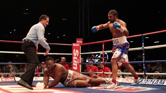 David Haye (right) knocks down Dereck Chisora in their WBA and WBO International Heavyweight Championship bout at Upton Park, London.