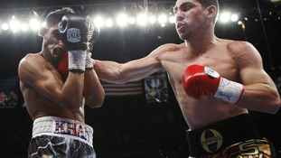 Khan takes a punch from Garcia.