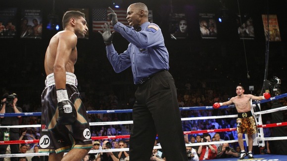 Referee Kenny Bayless gives count to Khan.