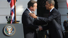 Prime Minister David Cameron and US President Barack Obama greet each other at the official welcoming ceremony