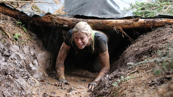 A participant tackles the Trench Warfare obstacle 